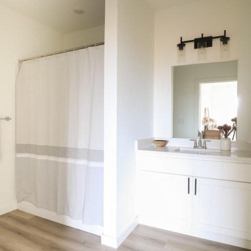 a spacious bathroom with a tub and vanity at The Flats at Hampden in Camp Hill, PA