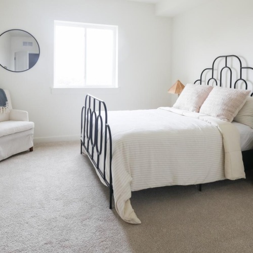 a carpeted bedroom with a window at The Flats at Hampden in Camp Hill, PA